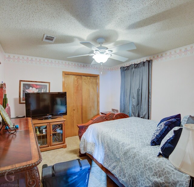 111 White Rd, Frierson, LA 71027 - carpeted bedroom with ceiling fan, a closet, and a textured ceiling