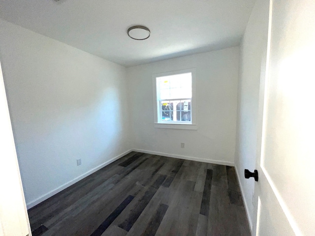 spare room with dark hardwood / wood-style floors