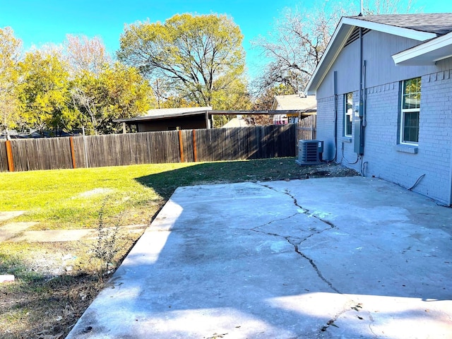 view of yard featuring central AC and a patio