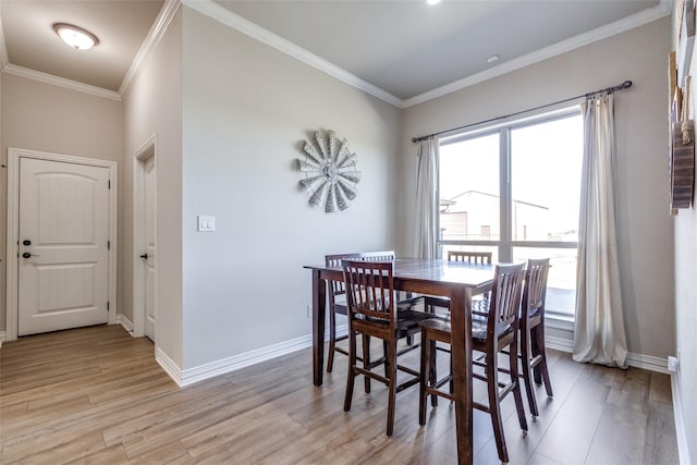 dining area featuring light hardwood / wood-style flooring and crown molding