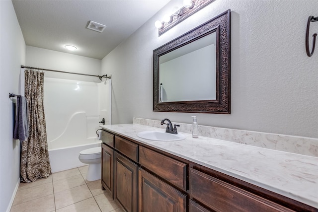 full bathroom featuring tile patterned floors, a textured ceiling, toilet, shower / tub combo with curtain, and vanity