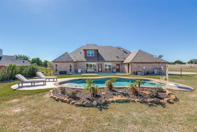 view of pool with a yard, central AC unit, and a patio area