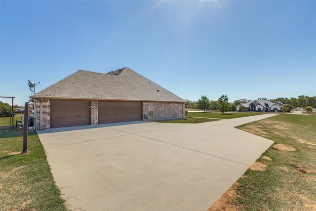 view of home's exterior with a lawn and a garage