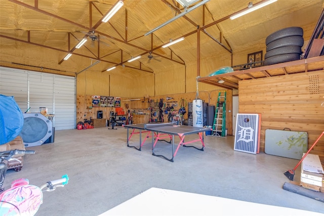 garage featuring a workshop area and wood walls