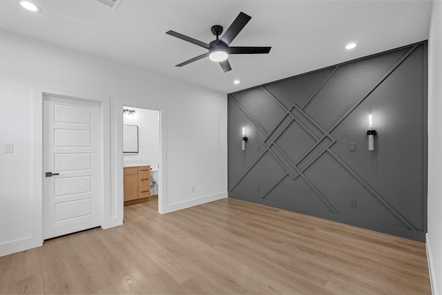 unfurnished bedroom featuring ceiling fan, connected bathroom, and light hardwood / wood-style flooring