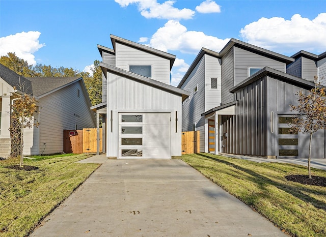 contemporary house featuring a garage and a front lawn