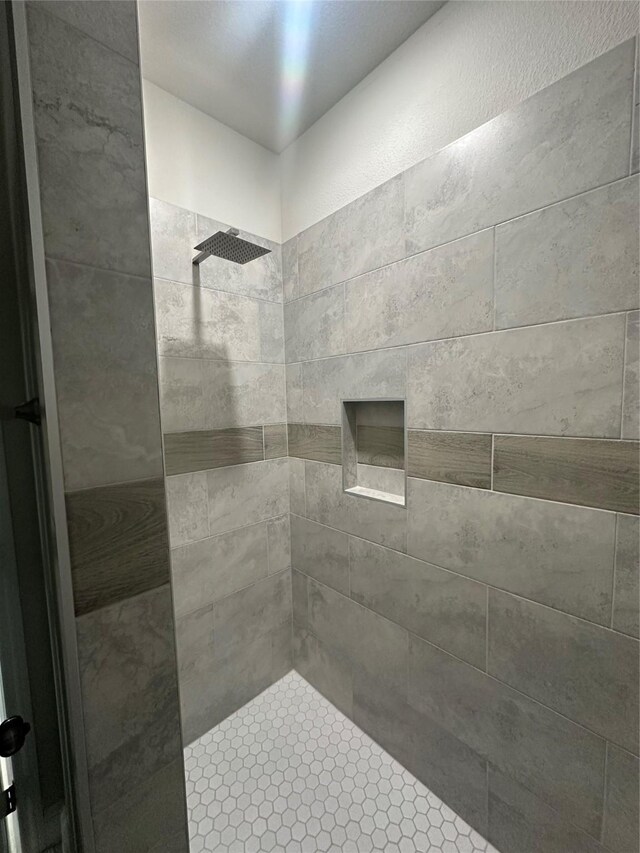 bathroom with a tile shower