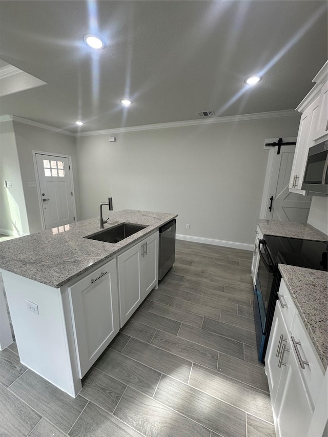 kitchen featuring dishwasher, a kitchen island with sink, white cabinets, black range with electric stovetop, and sink