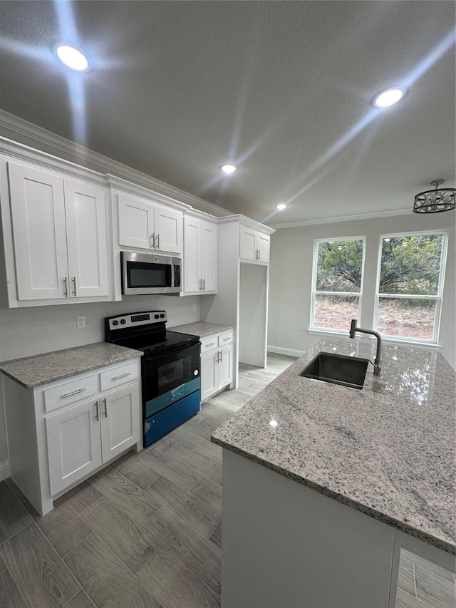 kitchen with white cabinetry, light stone countertops, sink, black electric range, and ornamental molding