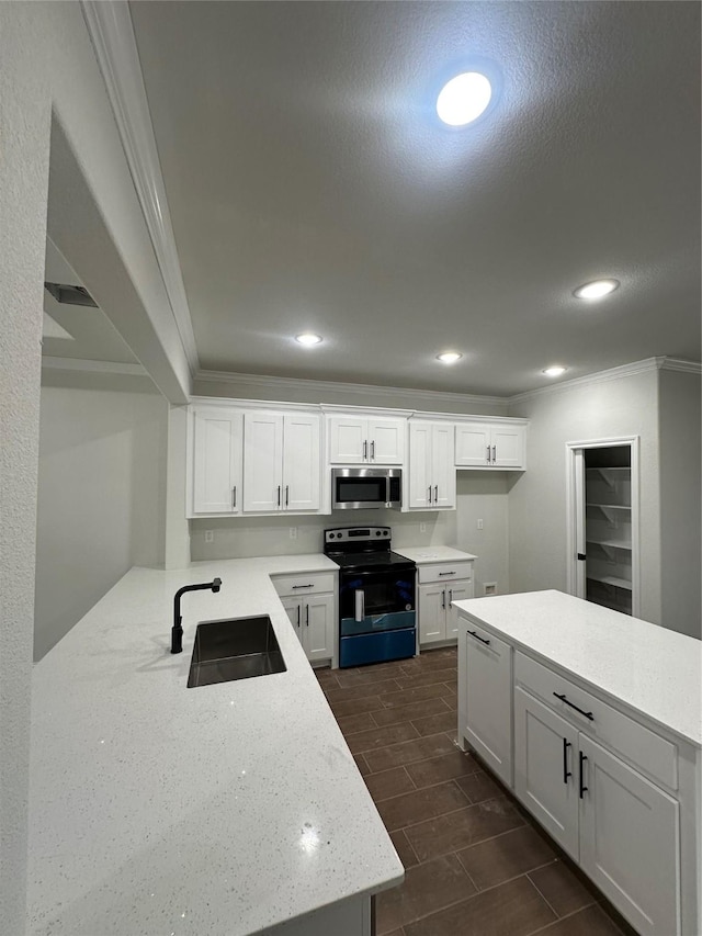 kitchen featuring electric range, crown molding, white cabinets, and sink