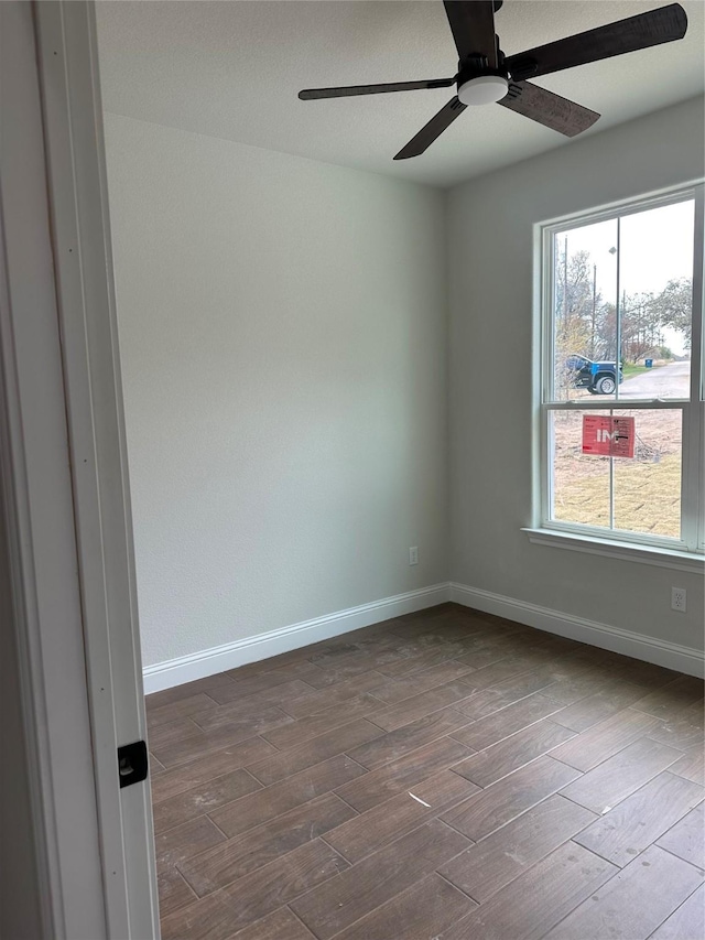 spare room with hardwood / wood-style flooring and ceiling fan