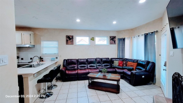 living room with light tile patterned floors and sink