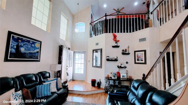 living room featuring ceiling fan and light hardwood / wood-style flooring