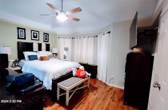 bedroom with ceiling fan and light wood-type flooring