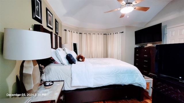 bedroom with hardwood / wood-style floors, ceiling fan, and lofted ceiling