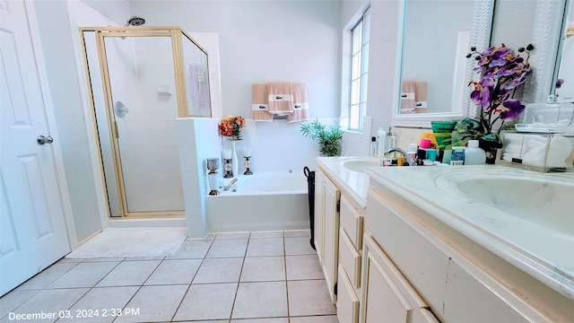 bathroom featuring independent shower and bath, vanity, and tile patterned floors