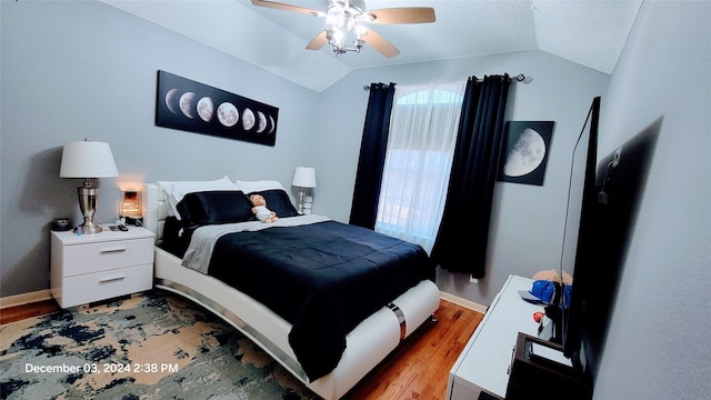 bedroom with light wood-type flooring, ceiling fan, and lofted ceiling