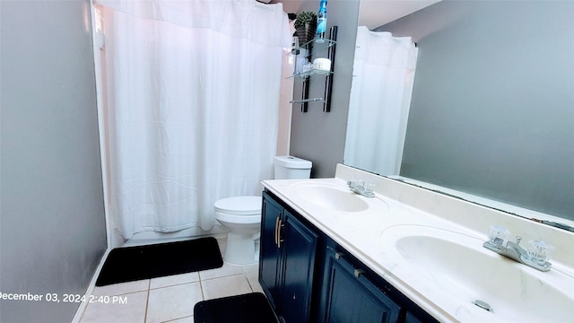 full bathroom with shower / bath combo with shower curtain, tile patterned floors, toilet, and vanity