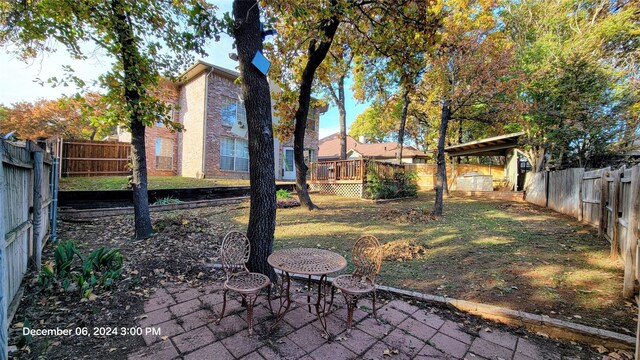 view of yard with a patio area and a wooden deck