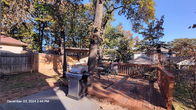 wooden terrace featuring grilling area