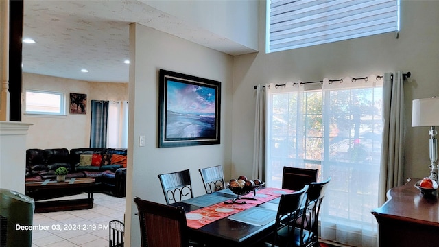 dining room featuring light tile patterned floors and a textured ceiling