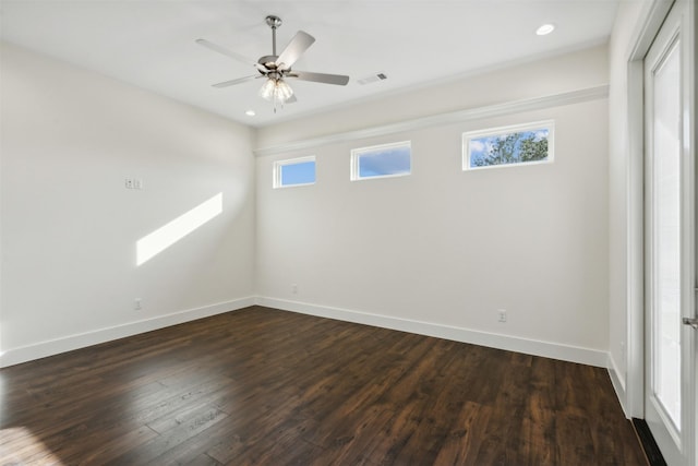 spare room featuring ceiling fan and dark hardwood / wood-style flooring