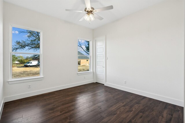 empty room featuring ceiling fan and dark hardwood / wood-style floors