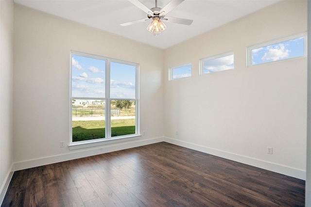 empty room with dark hardwood / wood-style floors and ceiling fan