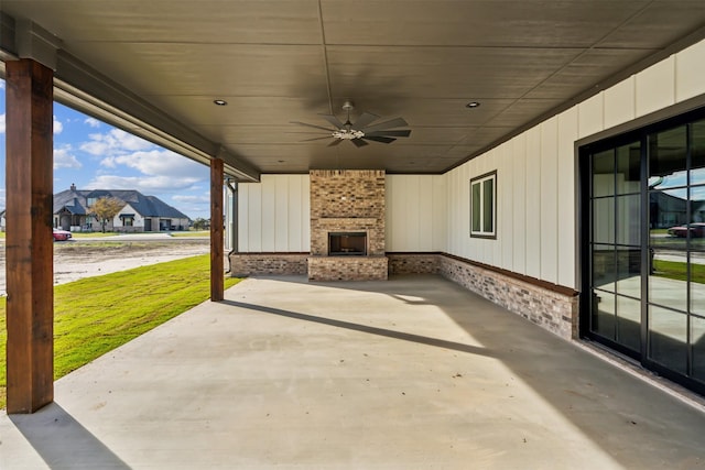 view of patio featuring an outdoor brick fireplace and ceiling fan