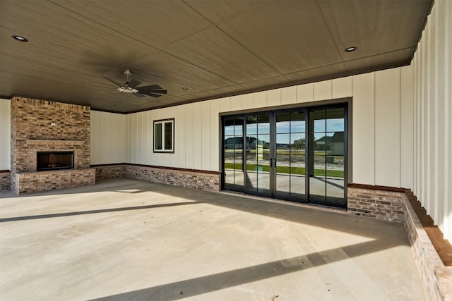 view of patio / terrace featuring ceiling fan and an outdoor brick fireplace