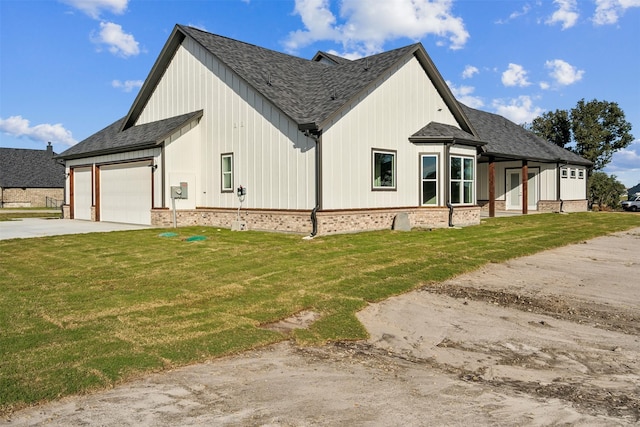 view of side of home with a yard and a garage