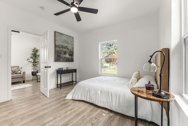 bedroom with light wood-type flooring and ceiling fan