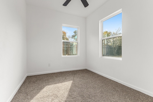 spare room with carpet floors, ceiling fan, and a healthy amount of sunlight