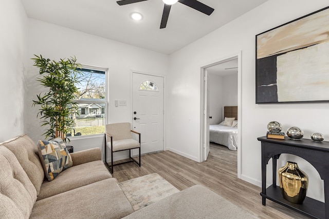 living room featuring light hardwood / wood-style floors and ceiling fan