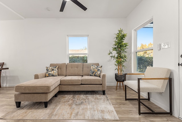 living room featuring a healthy amount of sunlight, ceiling fan, and light hardwood / wood-style floors