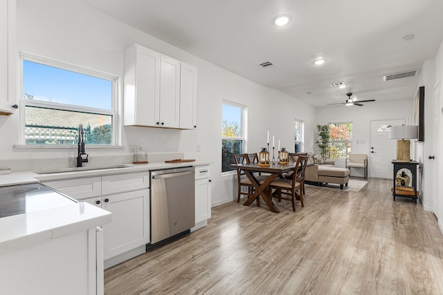 kitchen featuring dishwasher, plenty of natural light, white cabinetry, and sink