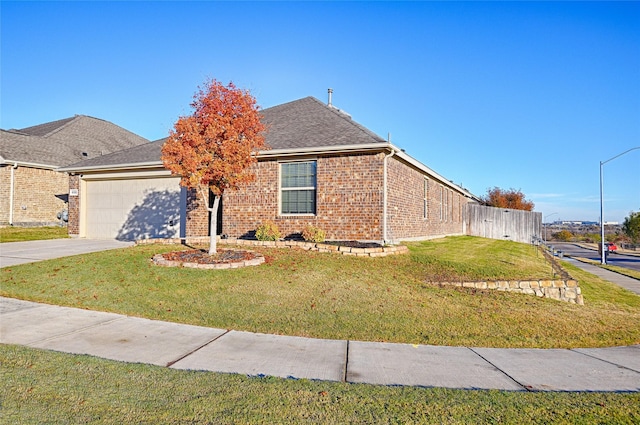 view of front of house featuring a front yard and a garage