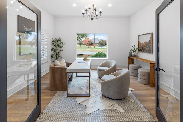 office space featuring french doors, an inviting chandelier, ornamental molding, and hardwood / wood-style flooring