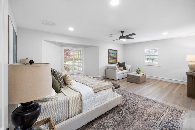 bedroom with hardwood / wood-style floors and ceiling fan