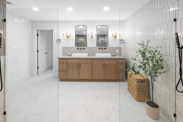 bathroom featuring vanity, a shower with shower door, and tile walls