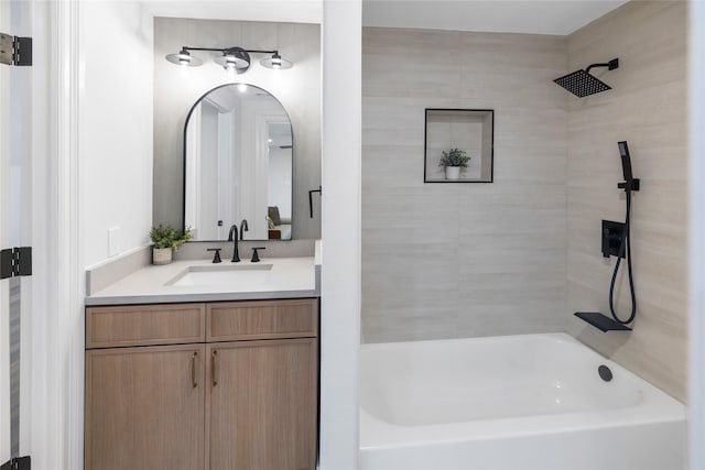 bathroom with vanity and tiled shower / bath combo