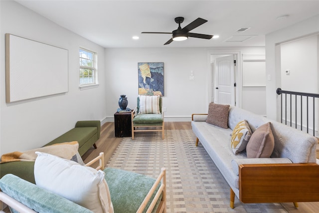 living room featuring ceiling fan and light wood-type flooring