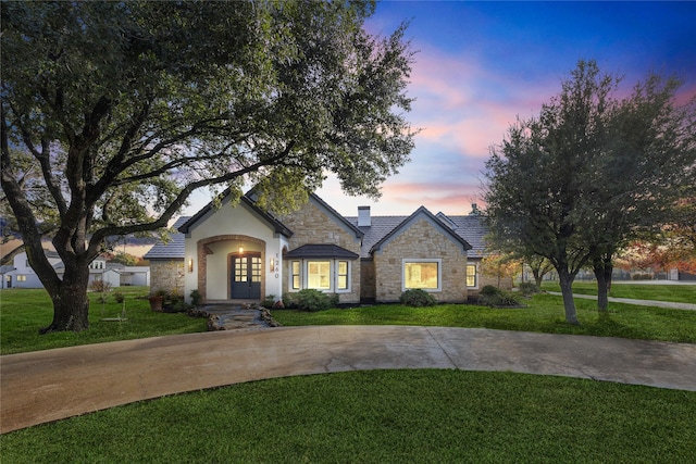 view of front of home with a yard and french doors