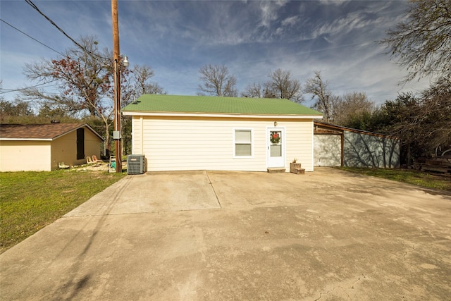 garage with central AC, a carport, and a yard