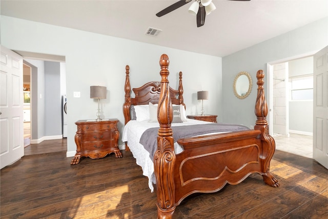 bedroom with ceiling fan, ensuite bath, and dark hardwood / wood-style flooring