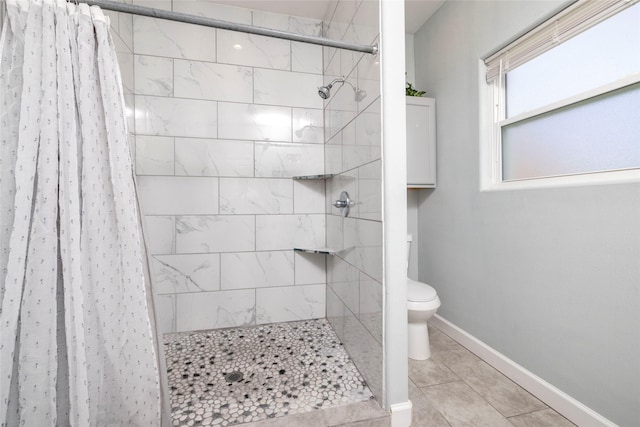 bathroom featuring toilet and a shower with curtain