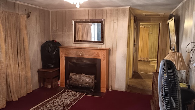 living area featuring ornamental molding and wooden walls