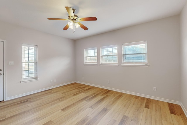 spare room with ceiling fan, light hardwood / wood-style flooring, and a healthy amount of sunlight