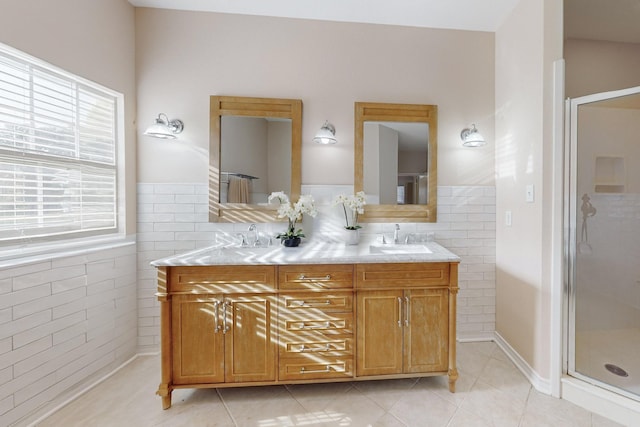 bathroom featuring tile walls, vanity, a shower with door, and tile patterned floors