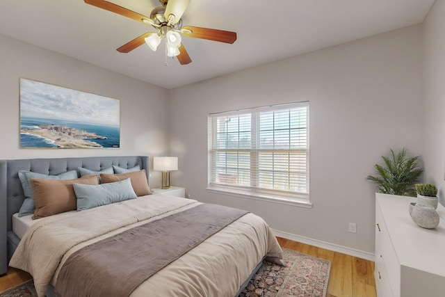 bedroom with ceiling fan and light wood-type flooring